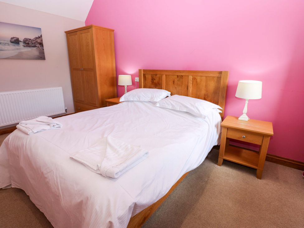 A bedroom with a bed and a nightstand at Pottowe Cottage in Potto near Stokesley
