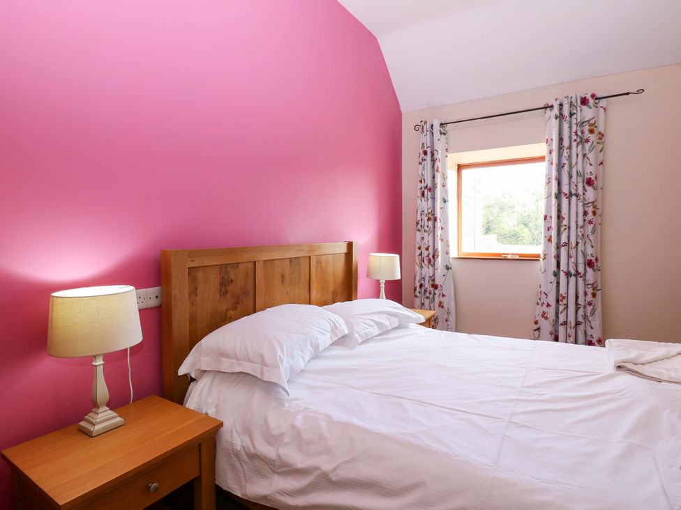 A bedroom with a bed and nightstand at Pottowe Cottage in Potto near Stokesley