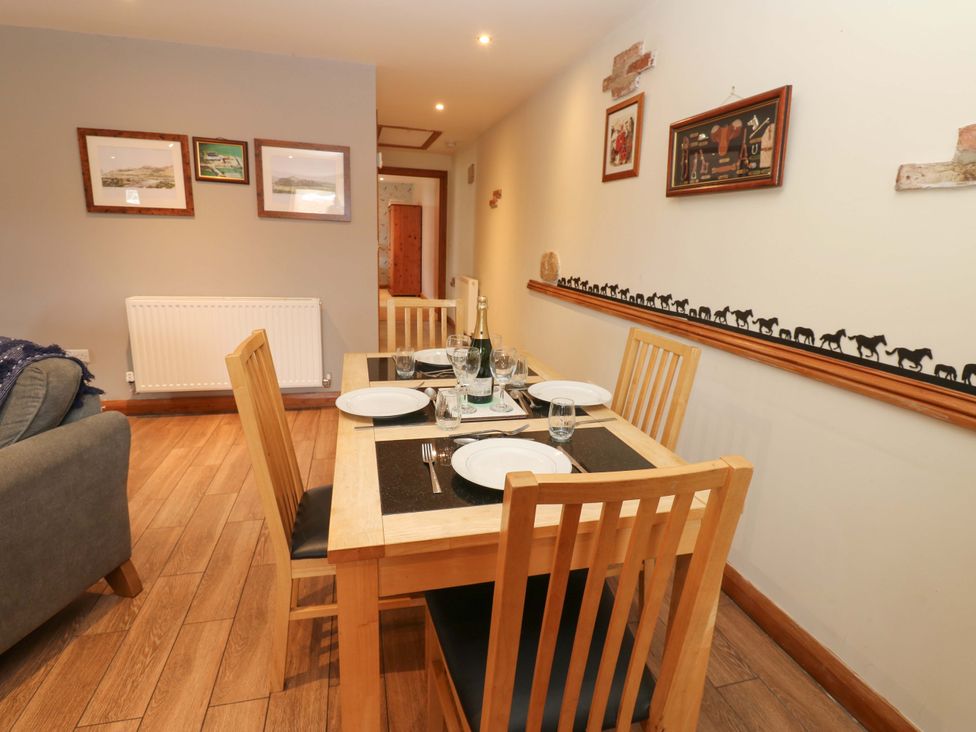 A dining room with a table set for a meal at Cooper Cottage in Potto near Stokesley