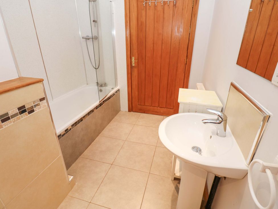 A bathroom with a bathtub and shower at Cooper Cottage in Potto near Stokesley
