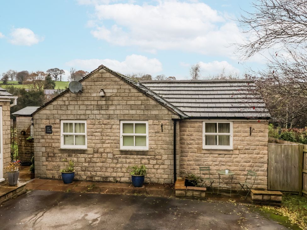 A cottage with windows and outdoor furniture at Lair Close Cottage Shaw Mills near Harrogate