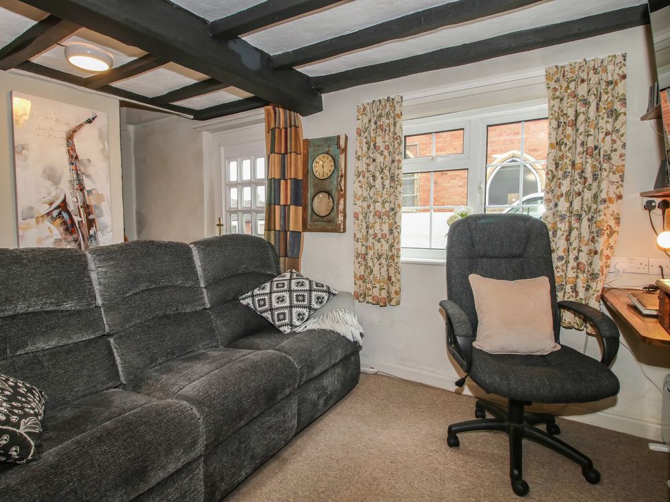 A sitting room with a sofa and armchair at Cariad Cottage in Ludlow