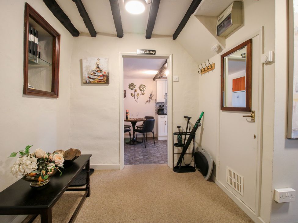 A hallway with a table and chairs visible in the background at Cariad Cottage in Ludlow