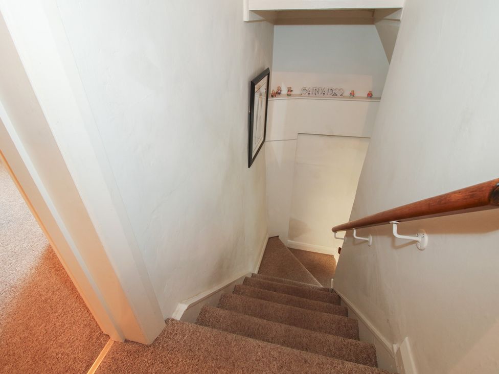 A staircase with a handrail at Cariad Cottage in Ludlow