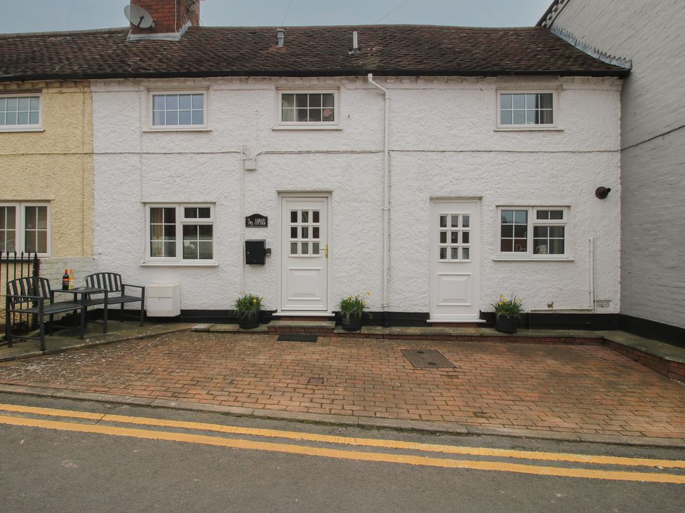 A house with a front door and windows at Cariad Cottage in Ludlow