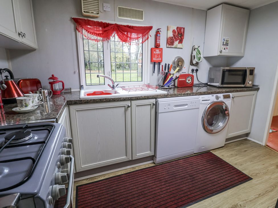 A kitchen with a sink and appliances at The Lodge in Old Buckenham near Attleborough