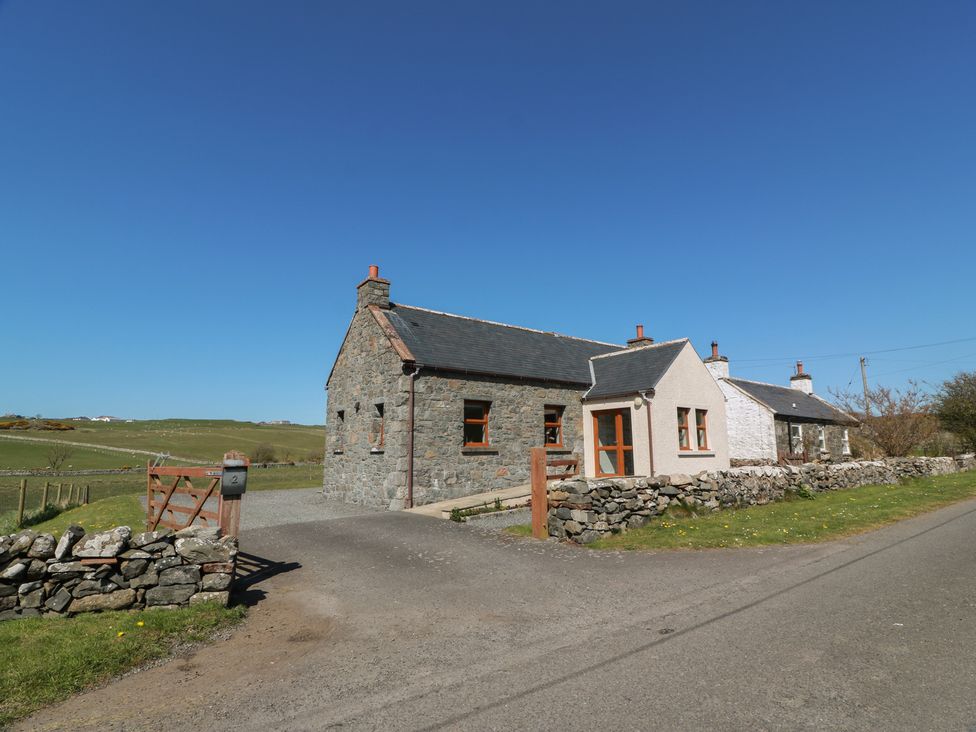 A house with a gate and stone wall near a road at South Milton Cottage in Stairhaven near Glenluce
