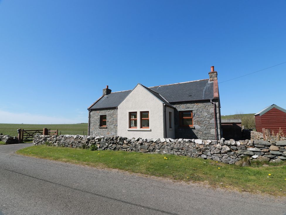A cottage with a stone wall and gate at South Milton Cottage Stairhaven near Glenluce