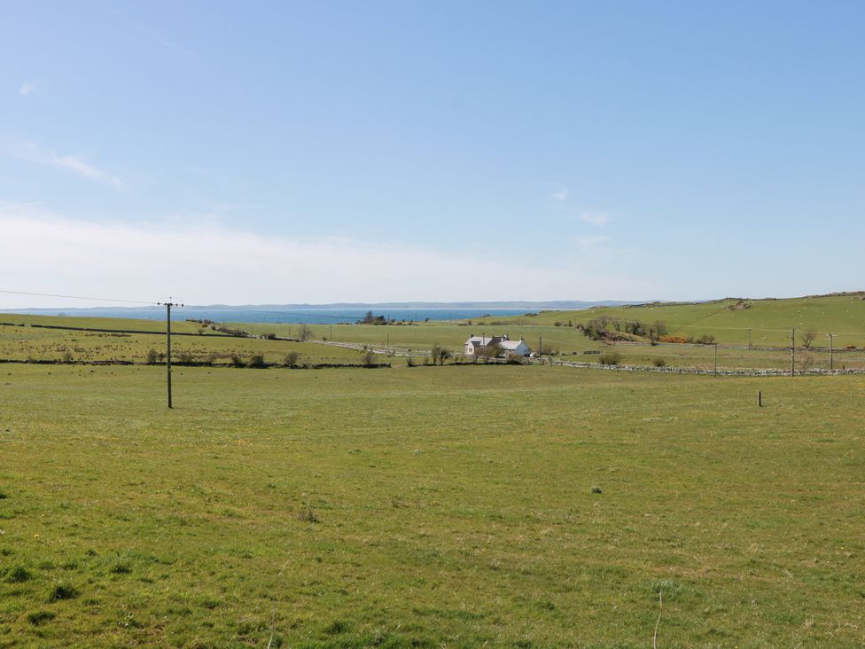 A scenic view of a house in a field at South Milton Cottage Stairhaven near Glenluce