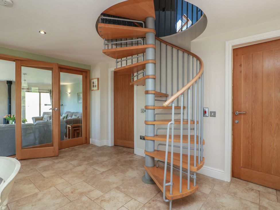 A spiral staircase in an entrance hall at South Milton Cottage Stairhaven near Glenluce
