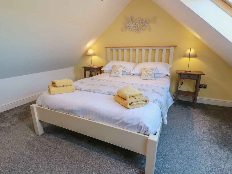 A bedroom with a double bed and nightstands at South Milton Cottage Stairhaven near Glenluce