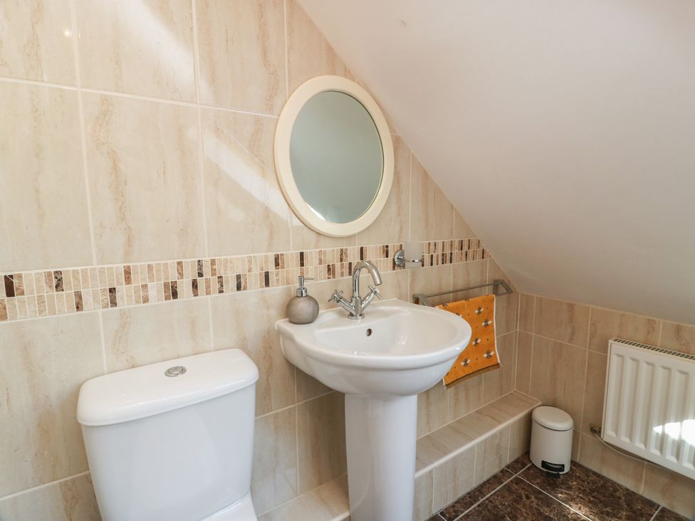 A bathroom with a sink and toilet at South Milton Cottage Stairhaven near Glenluce