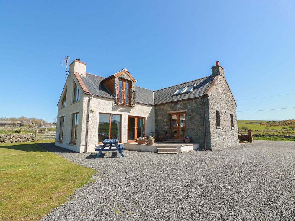A house with a balcony and gravel driveway at South Milton Cottage Stairhaven near Glenluce
