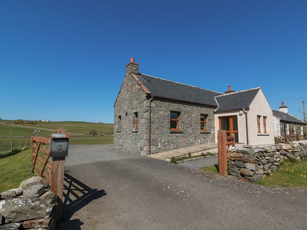 A cottage with stone wall and gravel driveway at South Milton Cottage Stairhaven near Glenluce