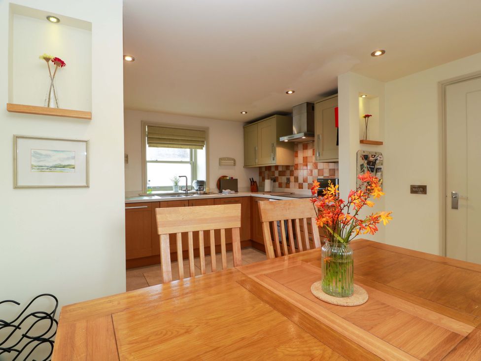 A kitchen with a dining table and chairs at Muirmailing Cottage Plean near Stirling