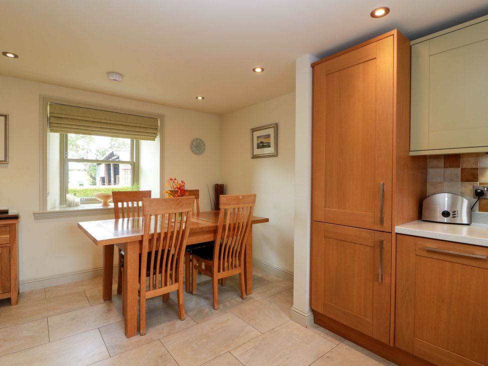 A kitchen with a dining table and window at Muirmailing Cottage Plean near Stirling