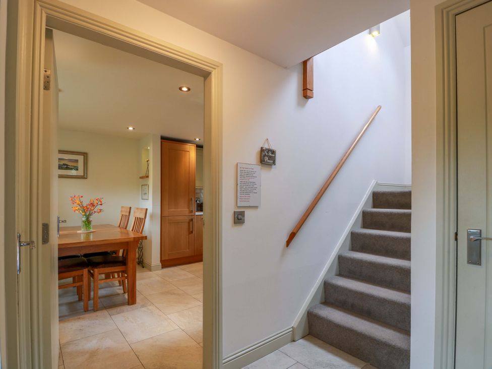 A dining room with a table and chairs at Muirmailing Cottage Plean near Stirling