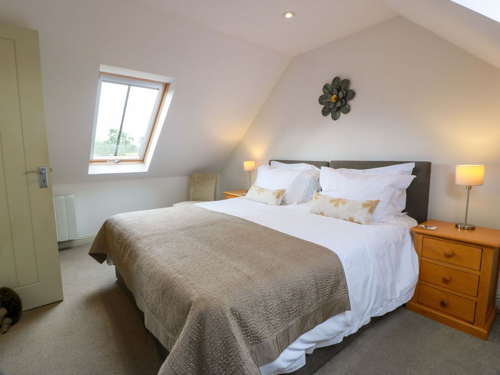 A bedroom with a bed and window at Muirmailing Cottage Plean near Stirling
