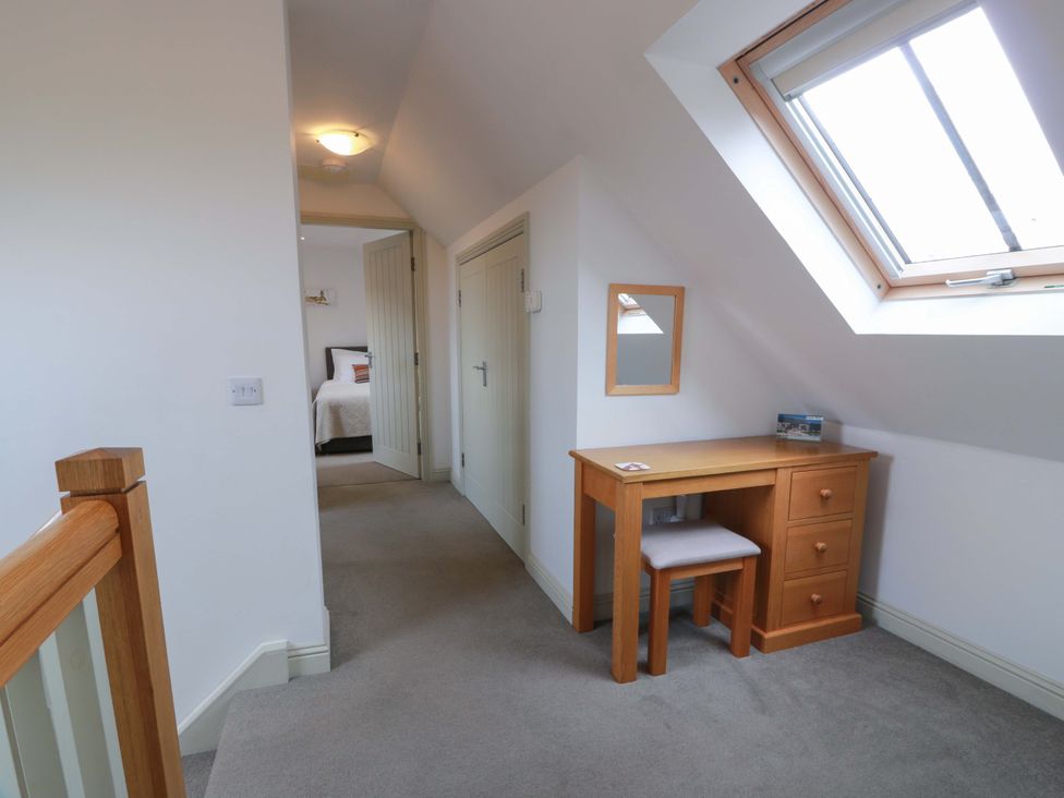 A hallway with a desk and chair near a window at Muirmailing Cottage Plean near Stirling