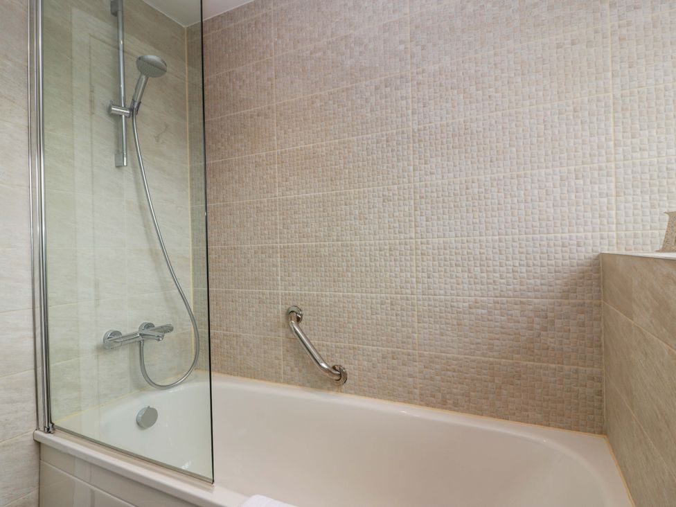 A bathroom with a bathtub and shower at Muirmailing Cottage Plean near Stirling
