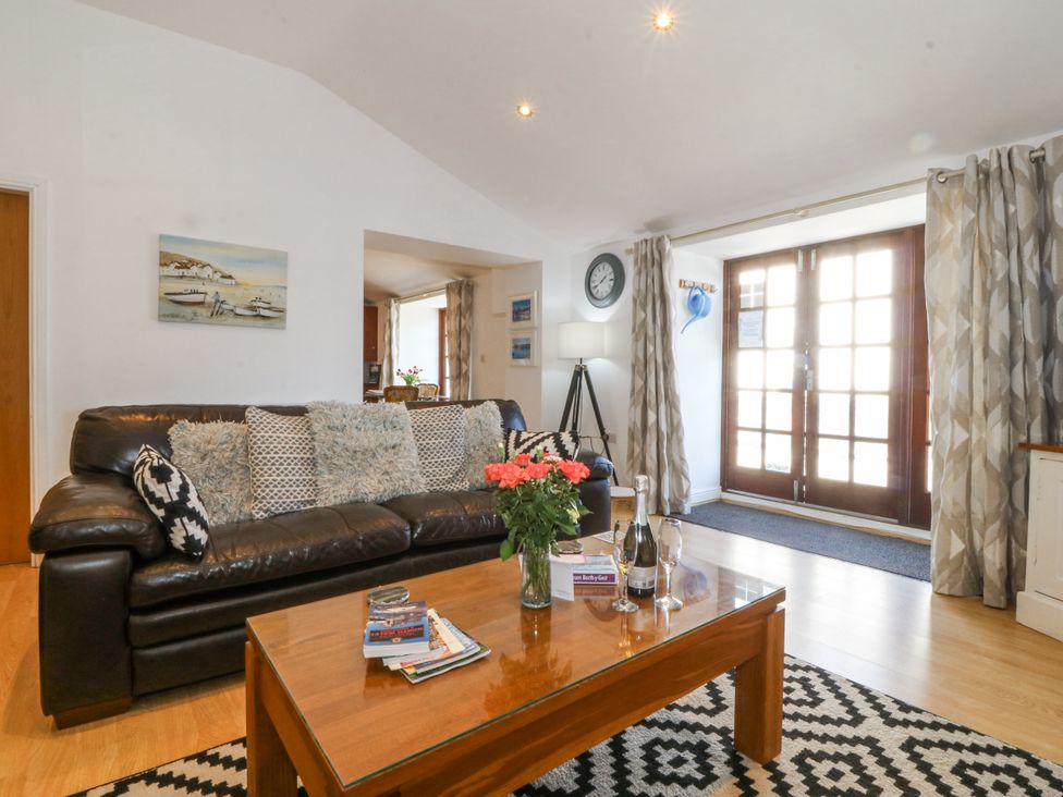A living room with a sofa and coffee table at Maritime Mews, 6 The Oakleys, Porthmadog
