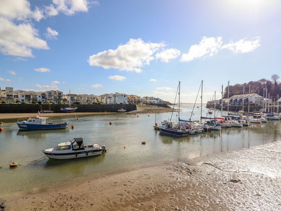 An outdoor view of boats in water with buildings in the background at Maritime Mews, 6 The Oakleys, Porthmadog