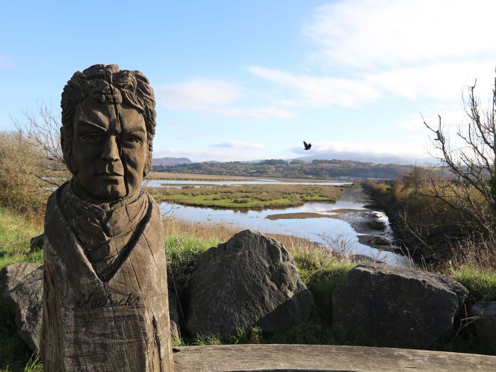 A wooden statue overlooking a river at Maritime Mews, 6 The Oakleys Porthmadog