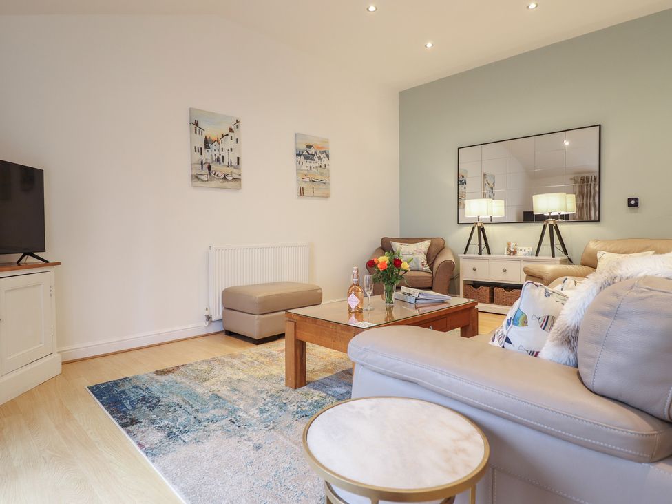 A living room with a sofa and coffee table at Maritime Mews, 6 The Oakleys Porthmadog