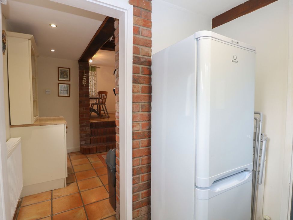 A kitchen with refrigerator and cabinets at Sleepeezy in Little Snoring