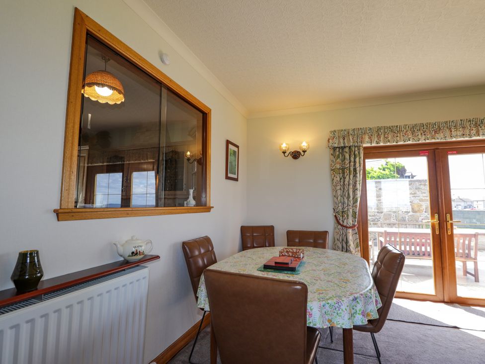 A dining room with a table and chairs at Braehead Croft in Portessie near Buckie