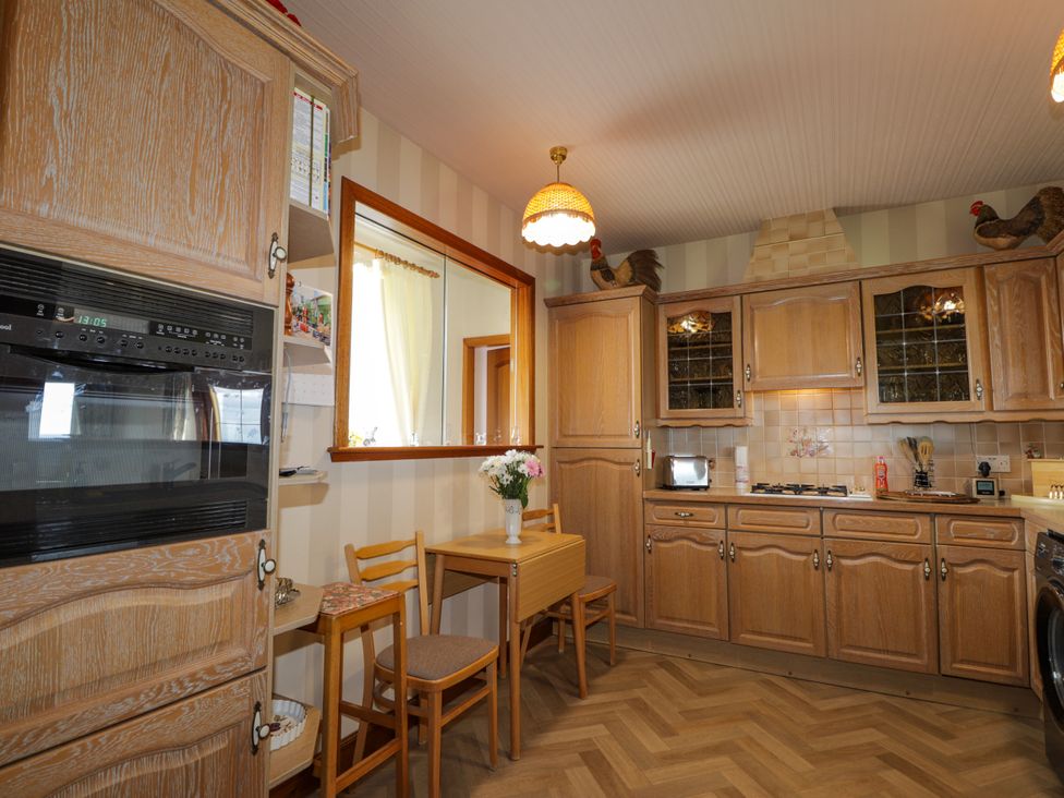 A kitchen with cabinets and appliances at Braehead Croft Portessie near Buckie