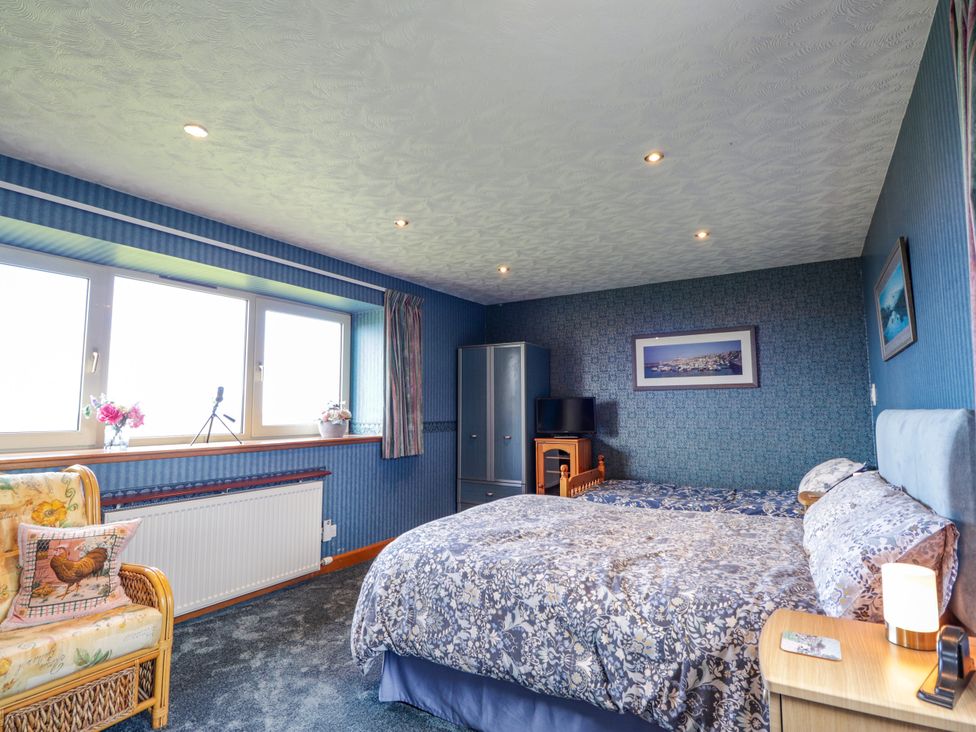 A bedroom with a bed and furniture at Braehead Croft near Buckie