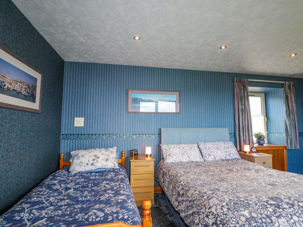 A bedroom with beds and a window at Braehead Croft in Portessie near Buckie