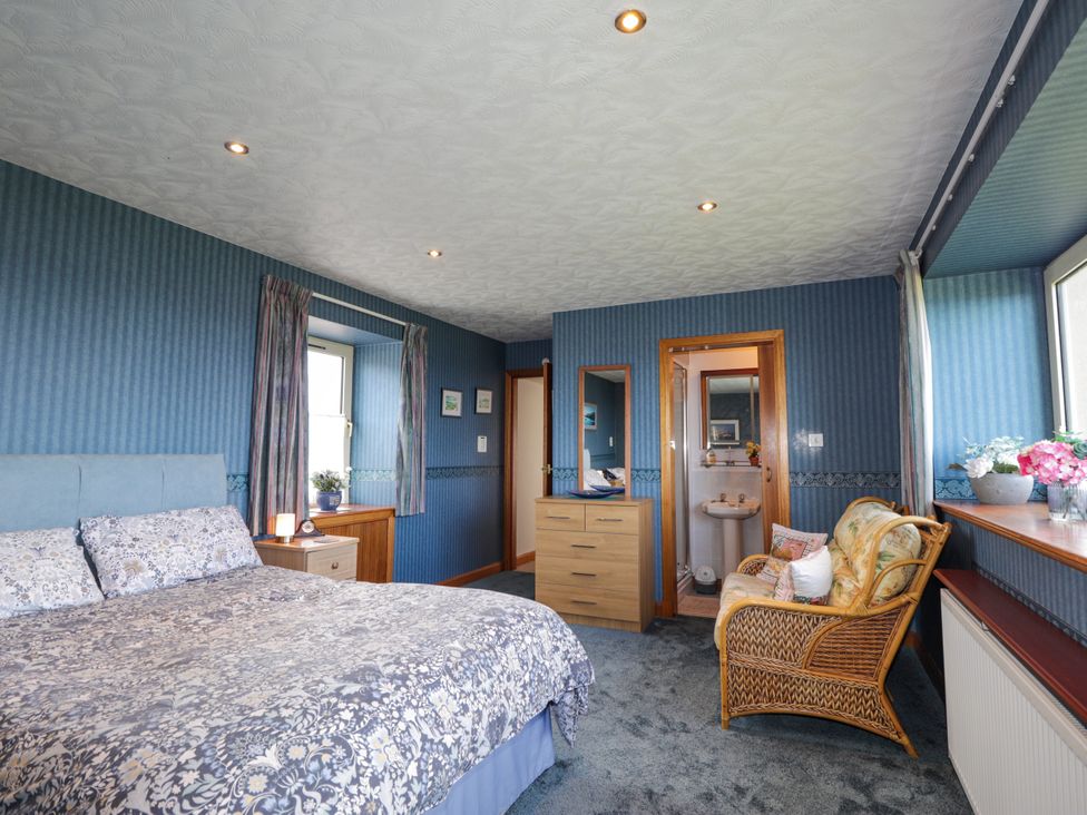 A bedroom with a bed and dresser at Braehead Croft, Portessie near Buckie