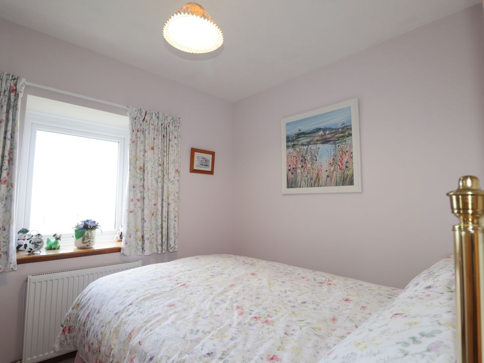 A bedroom with a bed and a window at Braehead Croft in Portessie near Buckie