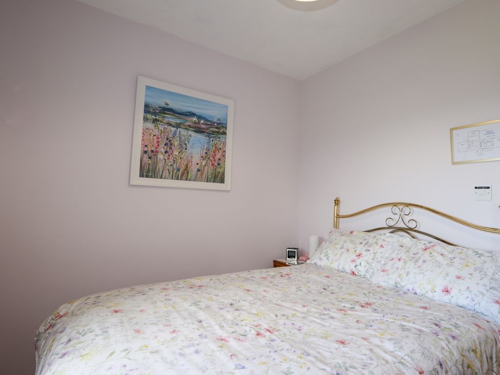 A bedroom with a bed and a bedside table at Braehead Croft in Portessie near Buckie