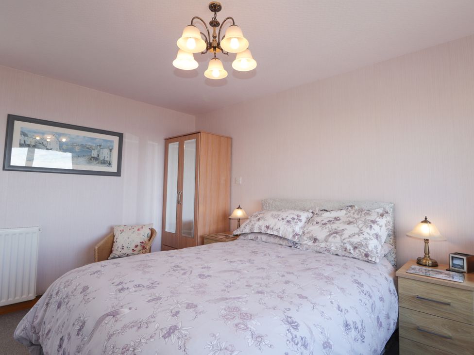 A bedroom with a bed and nightstand at Braehead Croft in Portessie near Buckie
