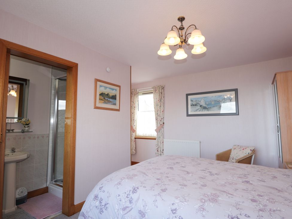 A bedroom with a bed and adjoining bathroom at Braehead Croft Portessie near Buckie