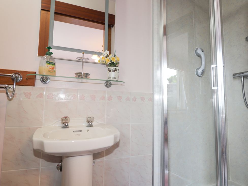 A bathroom with a sink and shower at Braehead Croft near Buckie