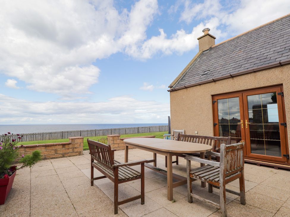 An outdoor patio with table and chairs at Braehead Croft Portessie near Buckie