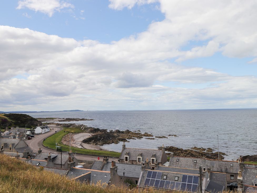 A coastal view with houses near a road and sea at Braehead Croft Portessie near Buckie