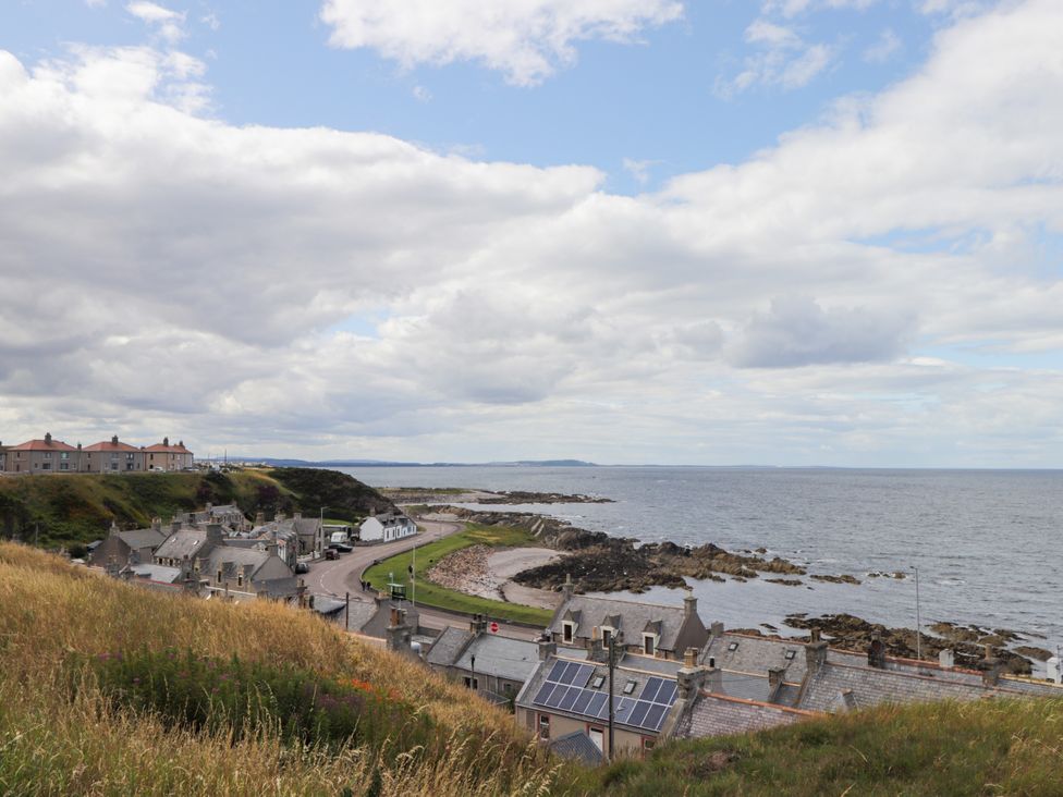 A view of the sea with houses along the shore at Braehead Croft Portessie near Buckie