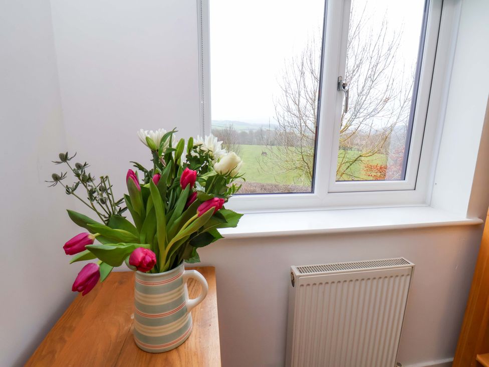 A vase with flowers on a windowsill at Berry Banks Cottage, Whitby