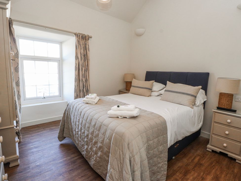 A bedroom with a bed and window at Hen Blas in Aberdaron