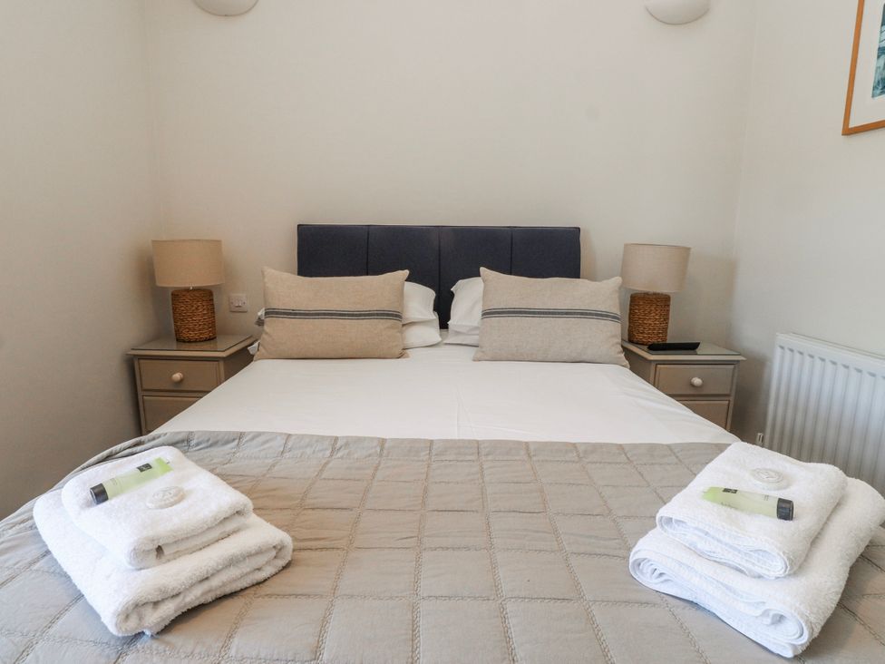 A bedroom with a bed and bedside tables at Hen Blas Aberdaron