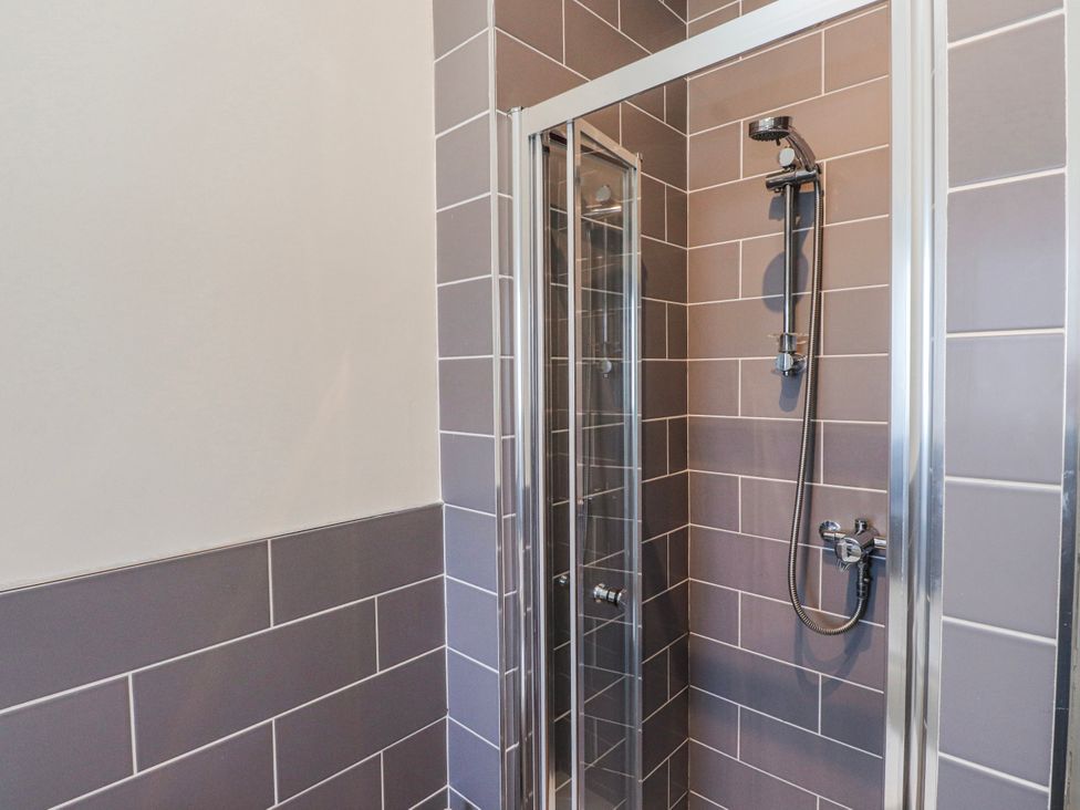 A shower enclosure with tiles at Hen Blas in Aberdaron