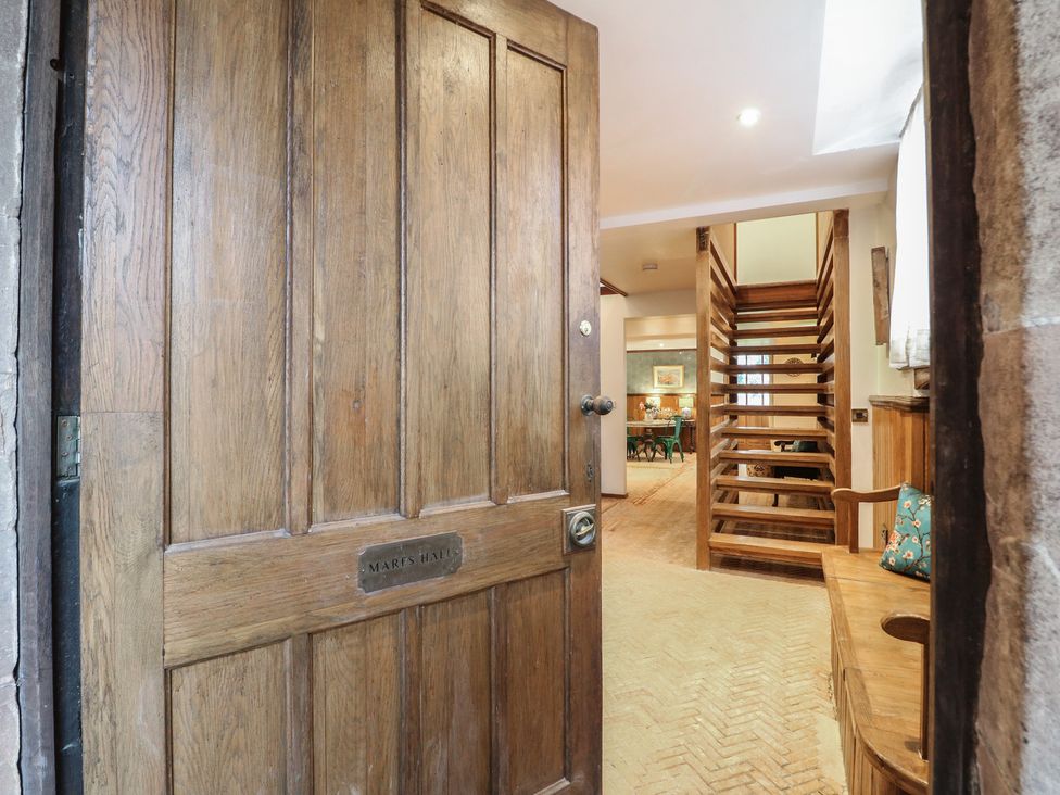 A doorway leading to a hallway with a staircase at Shrewsbury Lodge in Great Haywood