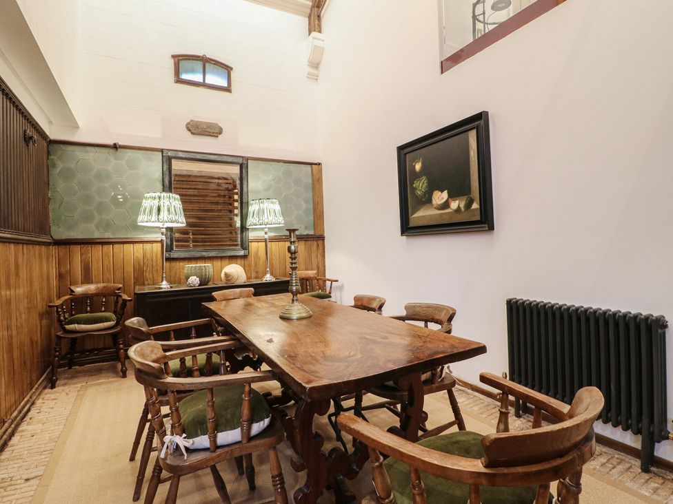 A dining room with a wooden table and chairs at Shrewsbury Lodge in Great Haywood