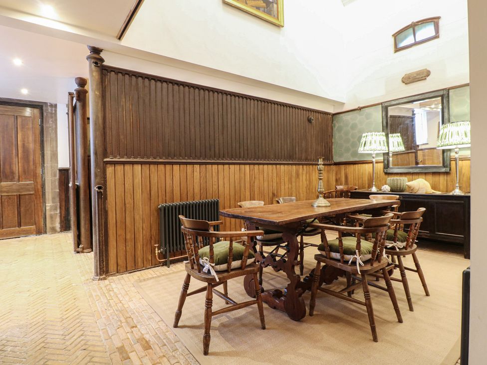 A dining room with a wooden table and chairs at Shrewsbury Lodge in Great Haywood