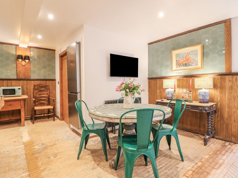 A dining room with a table and chairs at Shrewsbury Lodge in Great Haywood